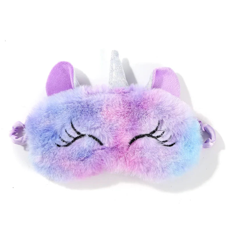 Unicorn-shaped eye mask with pastel colors on a white background