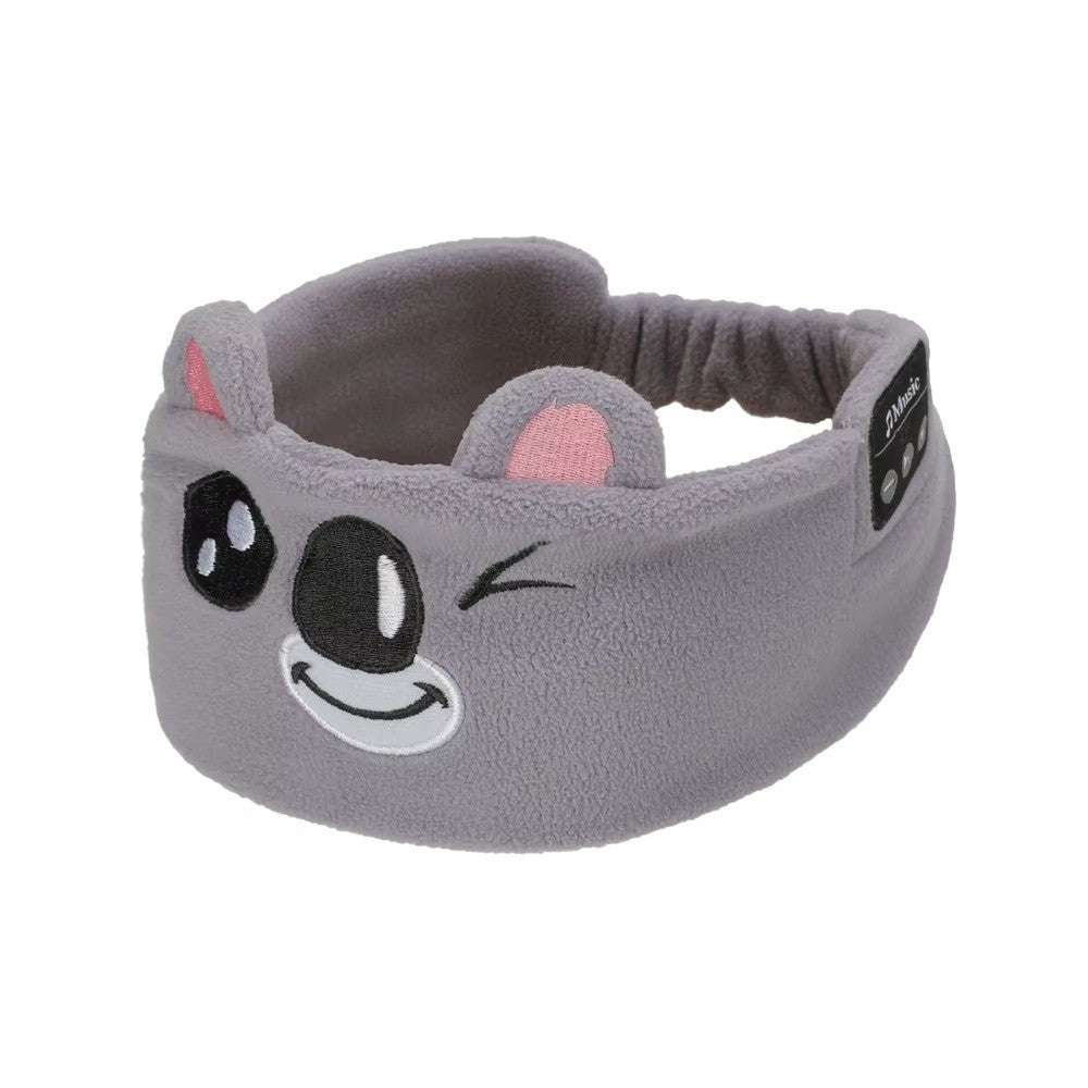 Gray sleep mask headphones with cartoon face design on a white background