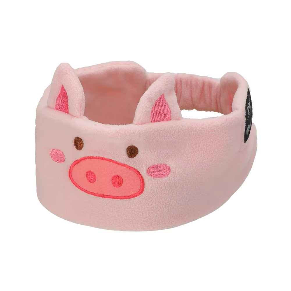 Pink pig-shaped sleep mask headphones on a white background