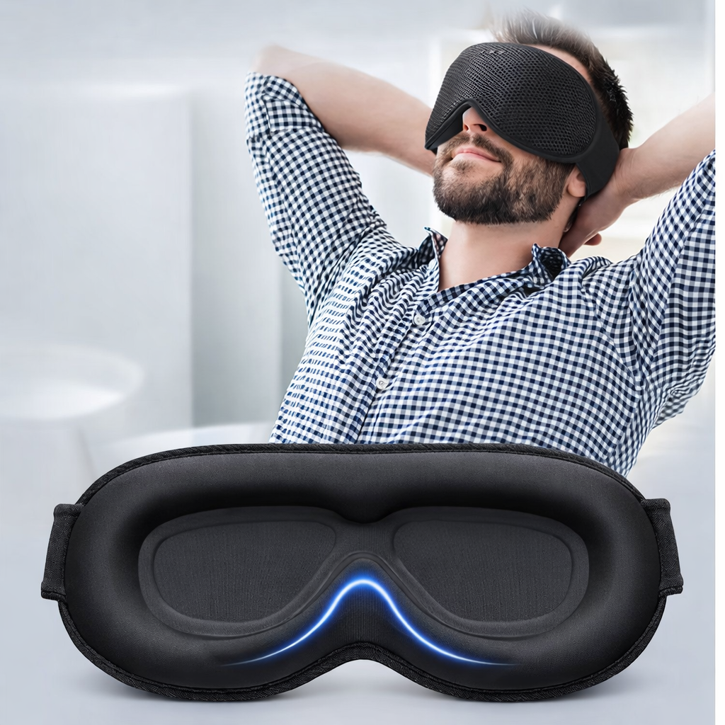 Man wearing a black sleep mask headphones with a matching eye mask in front