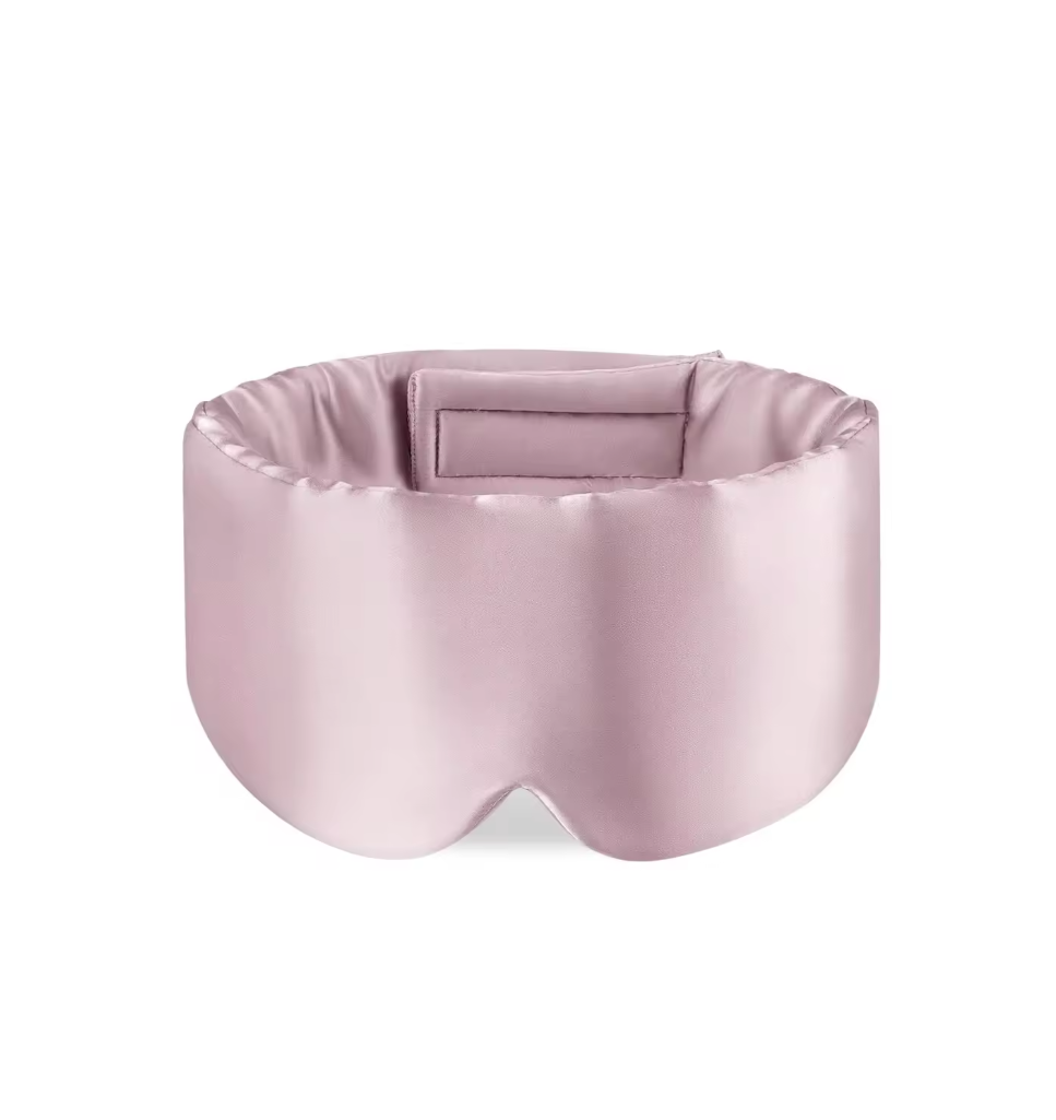 Pink satin eye mask on a white background