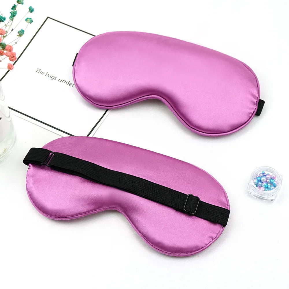 Two purple sleep masks on a white surface.